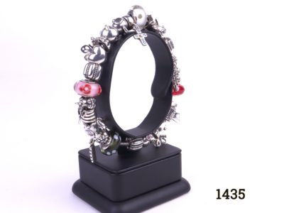 Pandora silver bracelet fully loaded with 22 charms Photo showing side view bracelet on stand