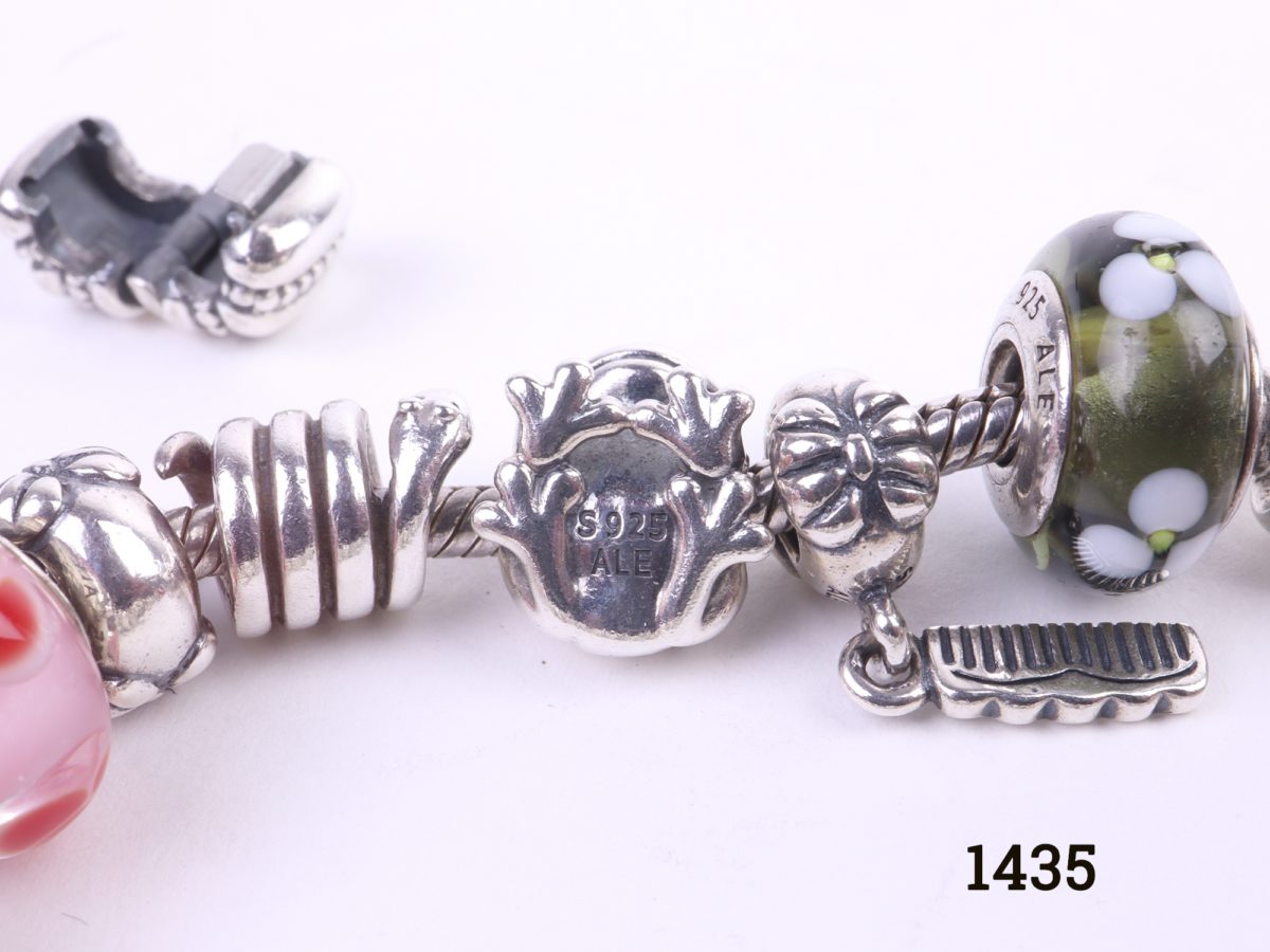 Pandora silver bracelet fully loaded with 22 charms Close up photo of charms showing hallmark