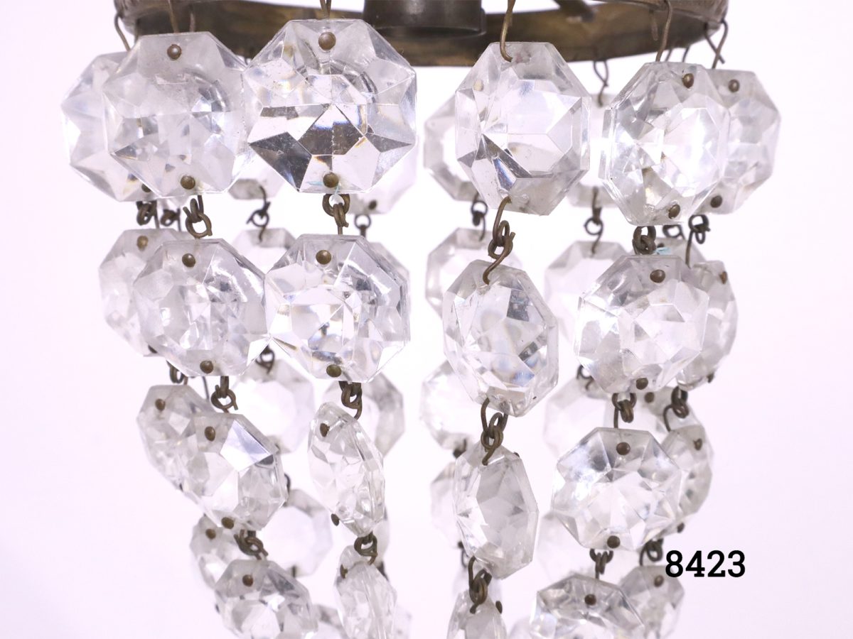 Small chandelier with bulb socket and ring in brass and cut crystal glass droplets Drop length from top of hook to base of chandelier 350mm Close up photo of the crystal droplets