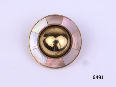 Ermani Bulatti clip-on earrings. Vintage gilt metal circular clip-on earrings with a raised round mound to centre surrounded by inlaid mother-of-pearl (Some gilt wear to centre at front and back). Measures 25mm in diameter Close up photo of front view of one earring