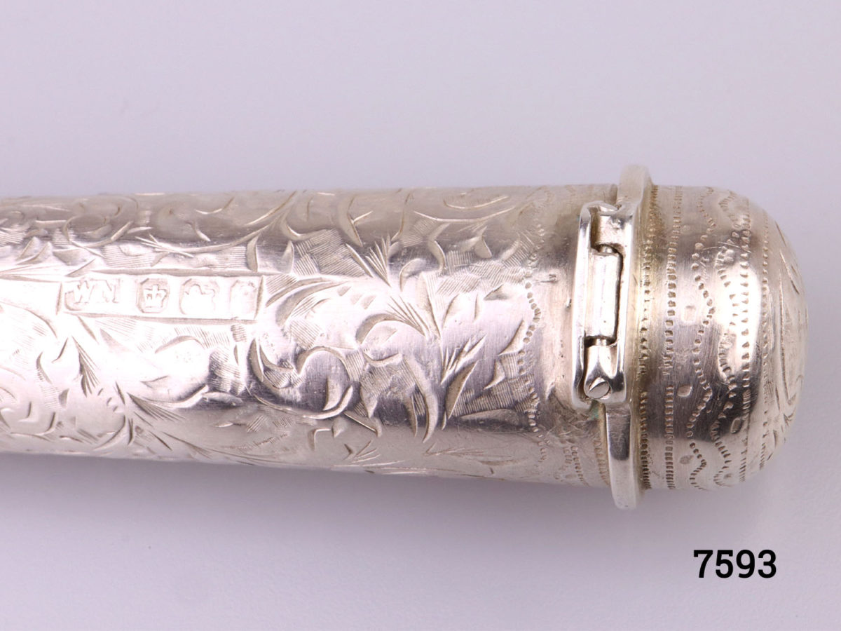 Antique Victorian sterling silver cheroot case with vacant cartouche for personalisation set in intricate scrollwork Hallmarked WN with a lion passant inside the lid (Currently housing small pencils) Close up photo of the hinge area
