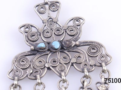 Decorative vintage steel chatelaine with grooming/manicuring tools attached. Intricate fine filigree worked metal with turquoise stone embellishment. 5 small tools attached including brush & tweezers. Possibly of Indian origin. (1 Stone missing from each side) Close up photo of the main filigree section showing one of the missing turquoise stones