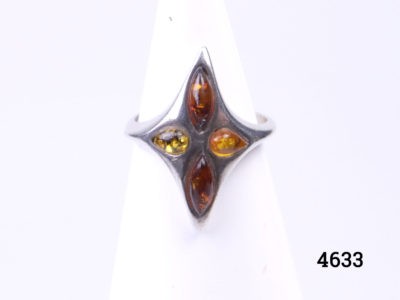 Vintage sterling silver ring set with 3 tones of amber ; cognac, butterscotch and green. Made in Gdansk Poland and hallmarked on the outer band to the back of the ring. Size M / 6.25 Photo of ring front displayed on a stand looking straight on