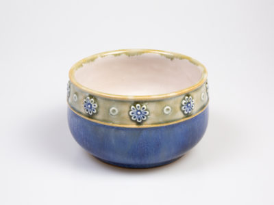 c1923 to 1927 small Royal Doulton bowl. Pretty bowl in iconic Doulton colours. Marked 8200 and accredited to artist Louisa Ayling. Measures approximately 85mm in diameter at base and 110mm across the top. Close up photo of the side of the bowl