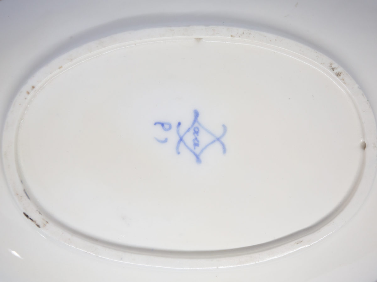 18th Century Sevres sauce boat. Soft paste porcelain sauce boat hand-painted in the feuille de choux pattern. Hairline crack to the inside of the sauce boat which does not come through under the plate. Interlaced L mark of Sevres to the base with double letter a denoting 1778. Photo of the Sevres mark at the base of the boat