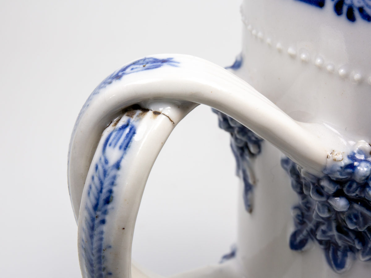 Antique Chinese blue and white tall mug. Rare mug from the Qianlong Li era c1736-1795. Decorated in classic willow pattern with an intricate and unusual 2 pleat handle. Small chip of the paint on the outer pleat handle and what appears to be a crack but most likely a consequence of the manufacturing process on the top of the inner pleat handle.  Otherwise in excellent condition for its age. Measures 82mm in diameter at base, 72mm across the top and 130mm at widest. Close up photo of the crack on the top of the inner pleat handle. The crack does not go all the way thru and is believed to be from the manufacturing process