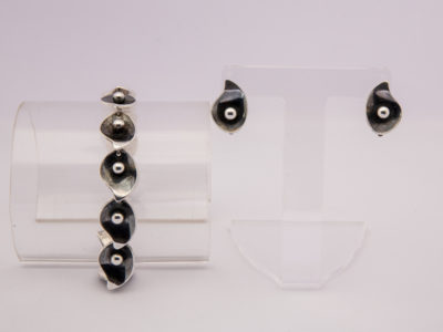 Danish sterling silver bracelet and earrings set. Beautifully handmade designer bracelet and clip-on earrings by S. Christian Fogh. Copenhagen 1947-1973. Bracelet measures 190mm long, 15mm wide weighs 31.9gms. Earrings measure 20mm long by 15mm wide and weighs 7.3gms. Photo of earrings and bracelet on separate display stands with bracelet to the left of photo