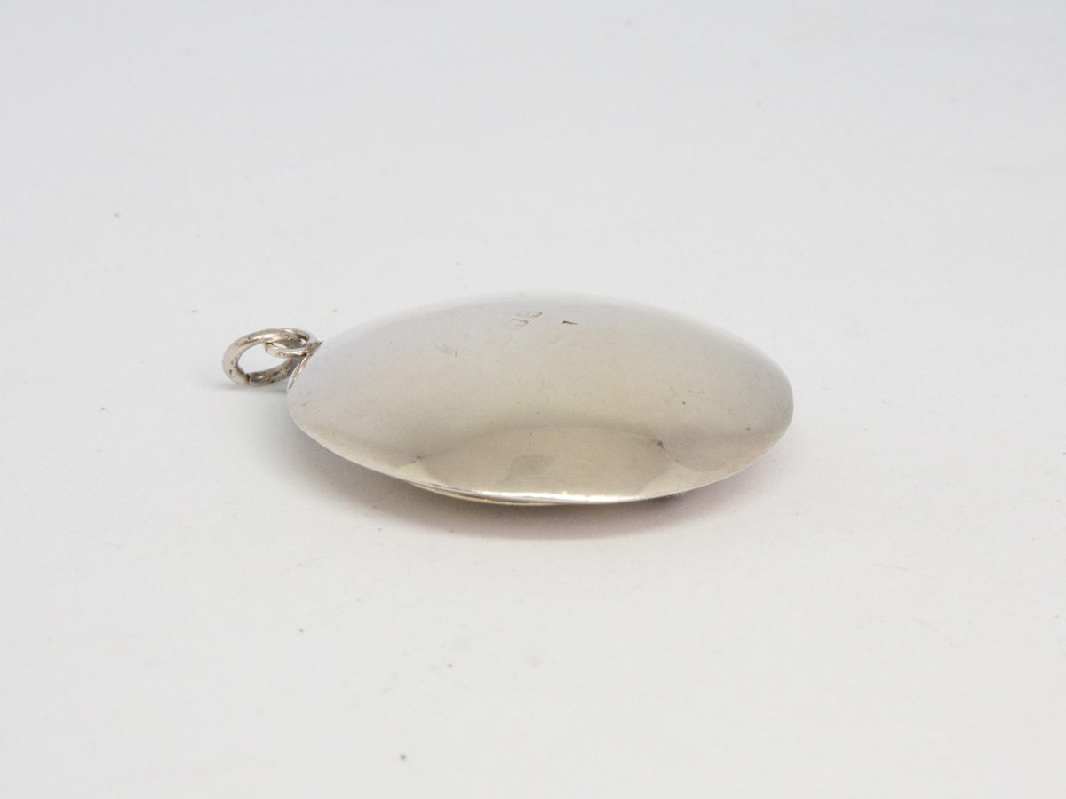 Small circular sterling silver compact. Vintage Art Deco chateleine compact with mirror and puff. Hallmarked for Birmingham assay (date stamp not readable). Measures 45mm in diameter. Photo of compact shown face down with ring area to right of photo