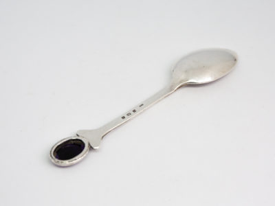 c1978 Sterling silver and Blue John spoon. Single sterling silver teaspoon with an oval Blue John stone to the handle tip. Nice column design to the handle stem. Photo of back of spoon which is laid diagonally across the photo with handle end to the bottom left