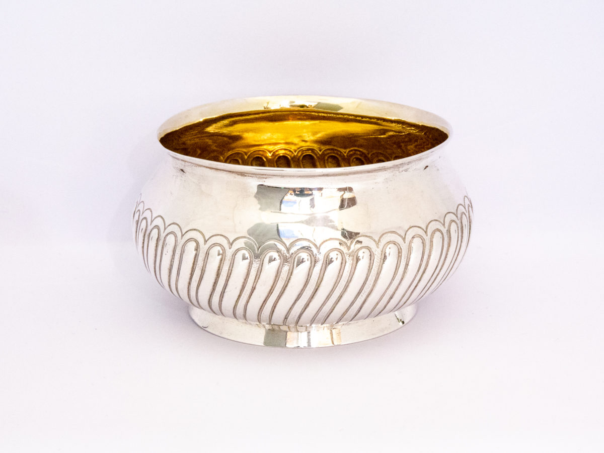 Edinburgh assayed sterling silver bowl. Lovely bulbous bowl with nice raised decorative work to the outside and a gilt silver interior. Fully hallmarked to the base and made by Hamilton & Inches c1881. Measures 80mm in diameter at base, 100mm across the top and approximately 120mm at bulbous central part. Photo showing mainly the outer silver area of bowl with a little peek at the gilt interior.