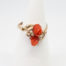 Continental carved coral roses ring. Pretty Continental gilt silver ring set with two carved red coral roses mounted on gilt silver leaves. Open band design. Size P. Hallmark to outside band (worn 800) Will be sent boxed. Main photo of ring on a cone display stand and seen with front forward..