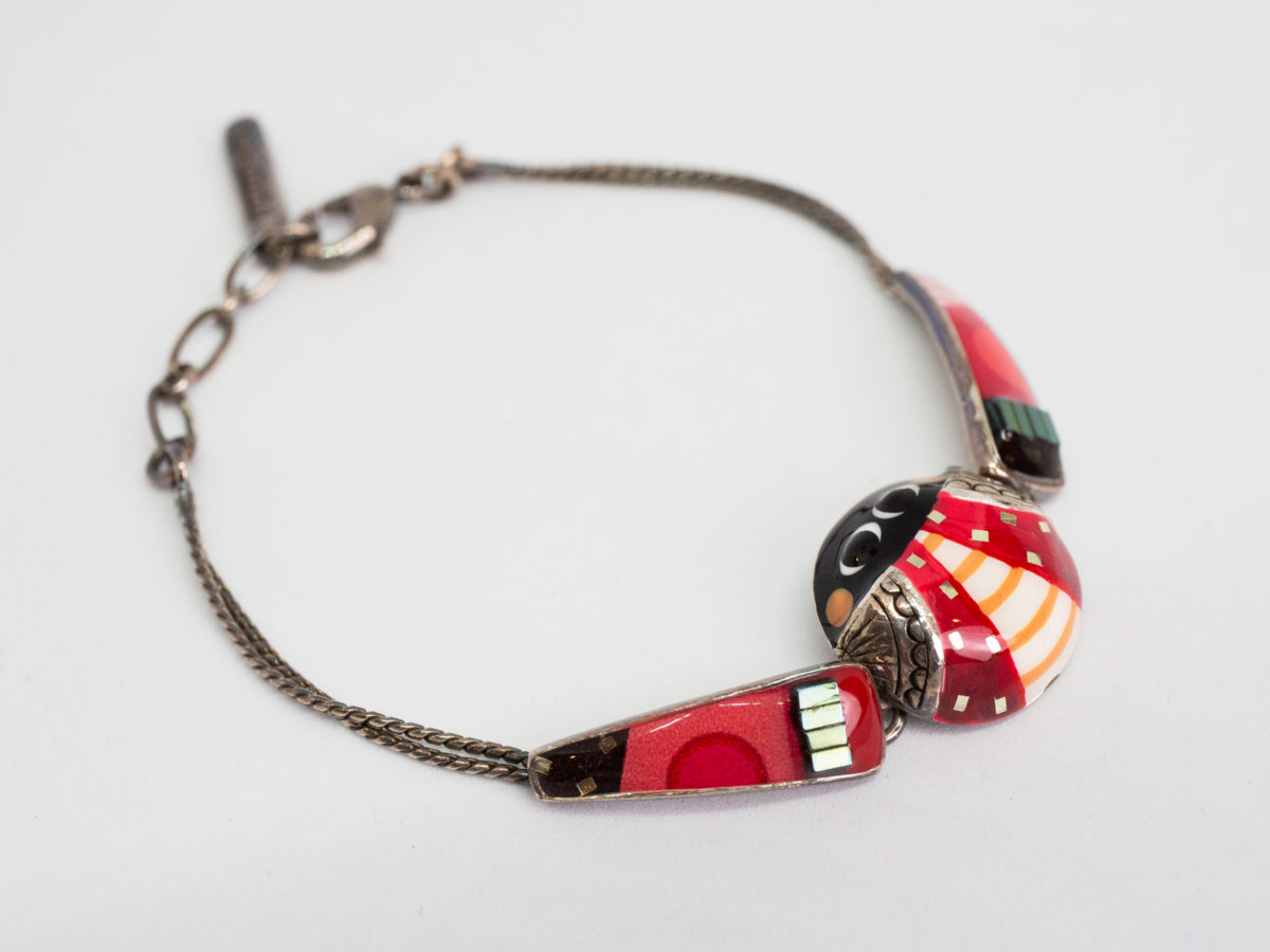 Modern metal & enamel ladybird bracelet. Fun and colourful ladybird bracelet in enamel set on white metal. Slightly adjustable from 160mm to185mm. Central section measures 17mm in diameter. Lovely gift item for children of all ages! Main photo of bracelet laid flat with the ladybird to the bottom right of photo.
