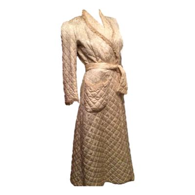 1930s cream silk quilted dressing gown in great condition. Wrap over and separate belt so quite free fitting from size 8 to 12. The only issue may be that the inside lining armhole needs attention, Main photo of full length of gown angled slightly to the right.