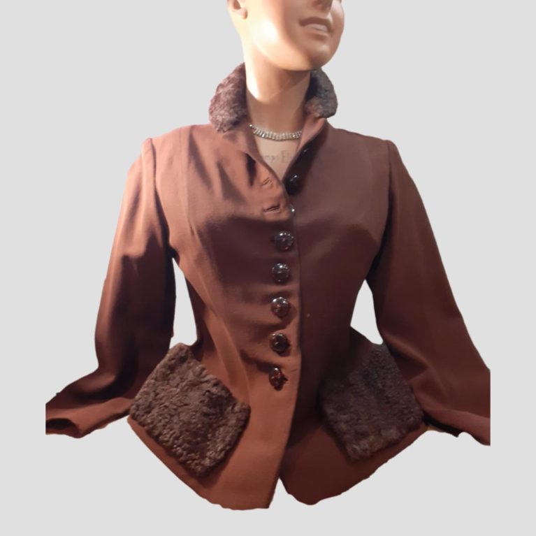 Main photo of the entire jacket seen from the front and modelled on a mannequin. Fitted waist again as were the jackets of way back then. Warm chocolatey brown main body with darker brown pockets and collar in a fleece like fabric. A style that never goes out of style.