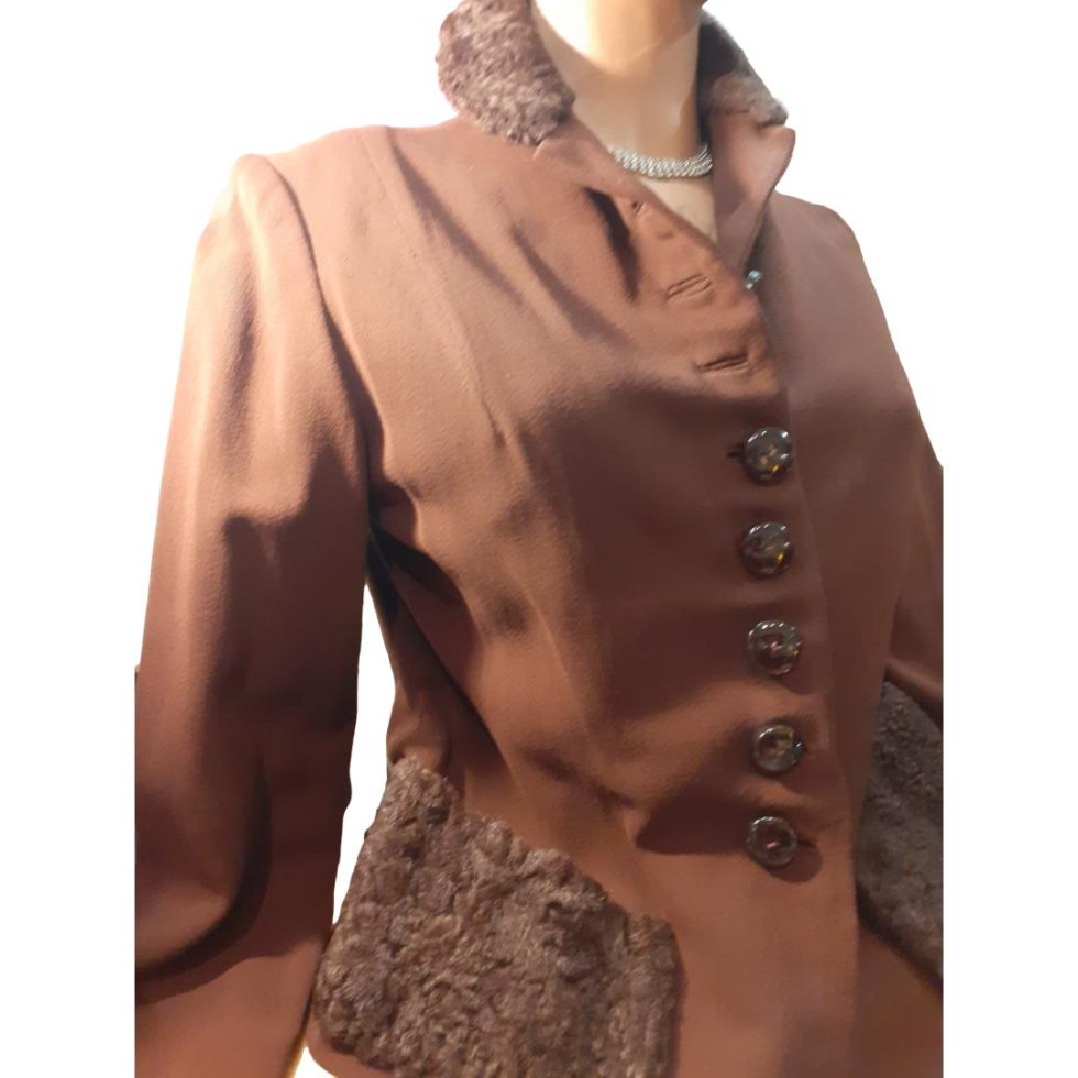 Photo of jacket seen from a slight angle with the front facing slightly right.