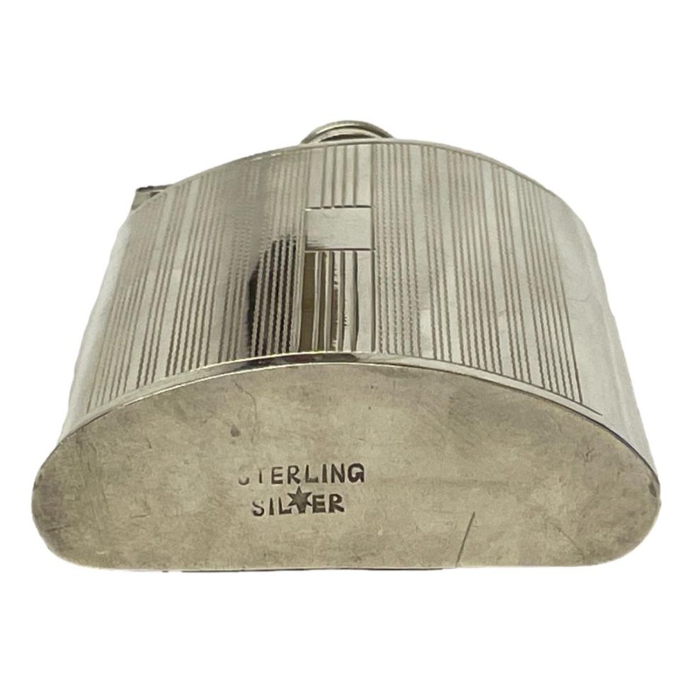 Photo of flask laid flat showing the hallmark to the base.