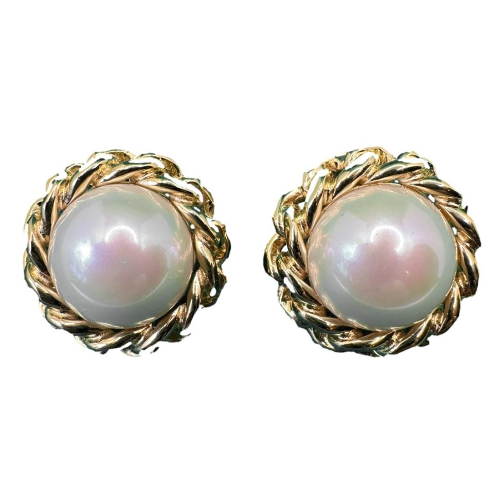 Main photo of earrings displayed side by side. The faux pearls are fairly large with a pinkish tinge with a twist rope work framing them all the way round.