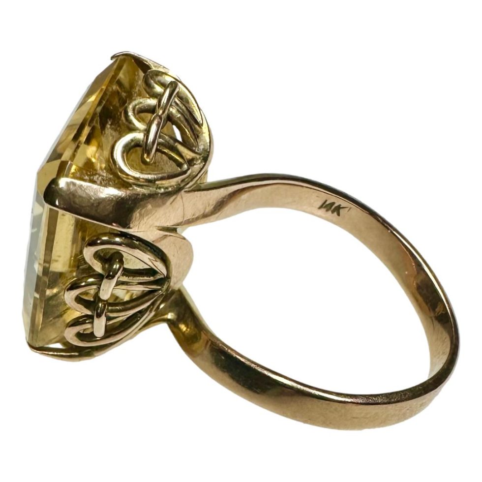 Photo of ring with the 14k hallmark visible to inside band. The ring front is facing away to the left.