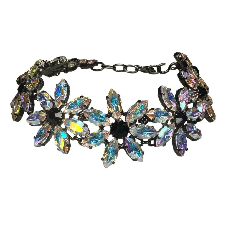 Main photo of necklace set on a flat surface and displayed in a circular way as if worn around a neck with clasp fastened. This necklace matches the clip on earrings sold separately with 6 petaled flowers with crystal 'petals'