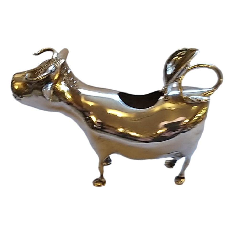 Photo of creamer with the fill flap at the centre of cows back open.