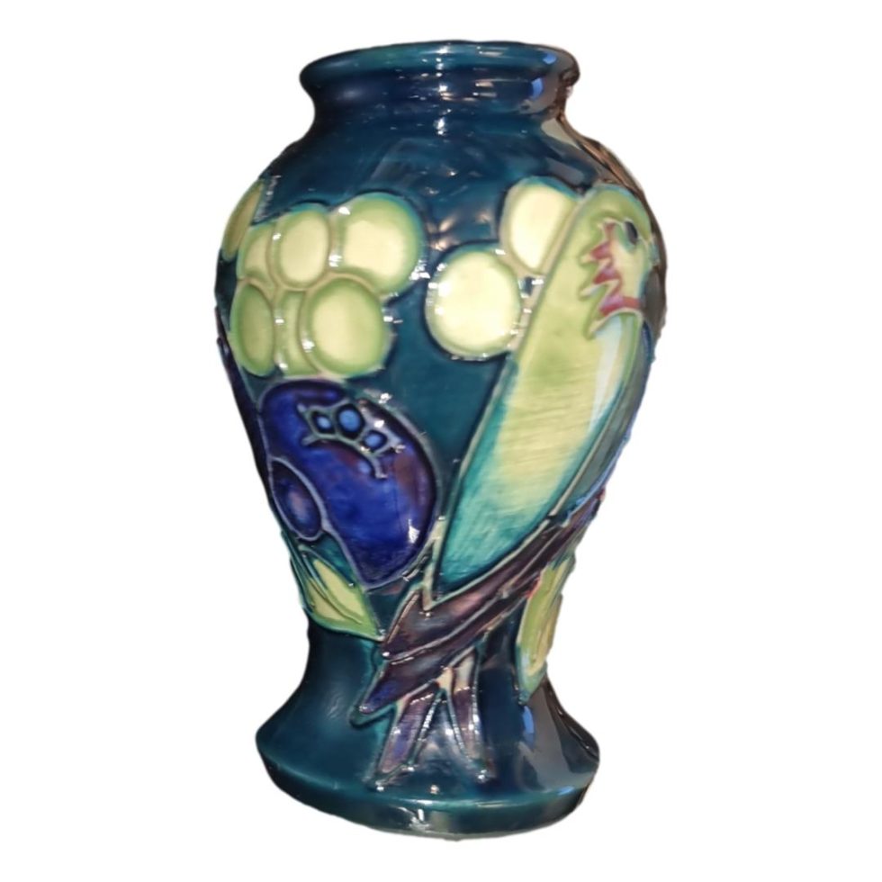 Main photo of vase seen from an eye level the face and beak of the finch is slightly out of shot but the beautiful blue and green hue of the entire vase is clearly shown