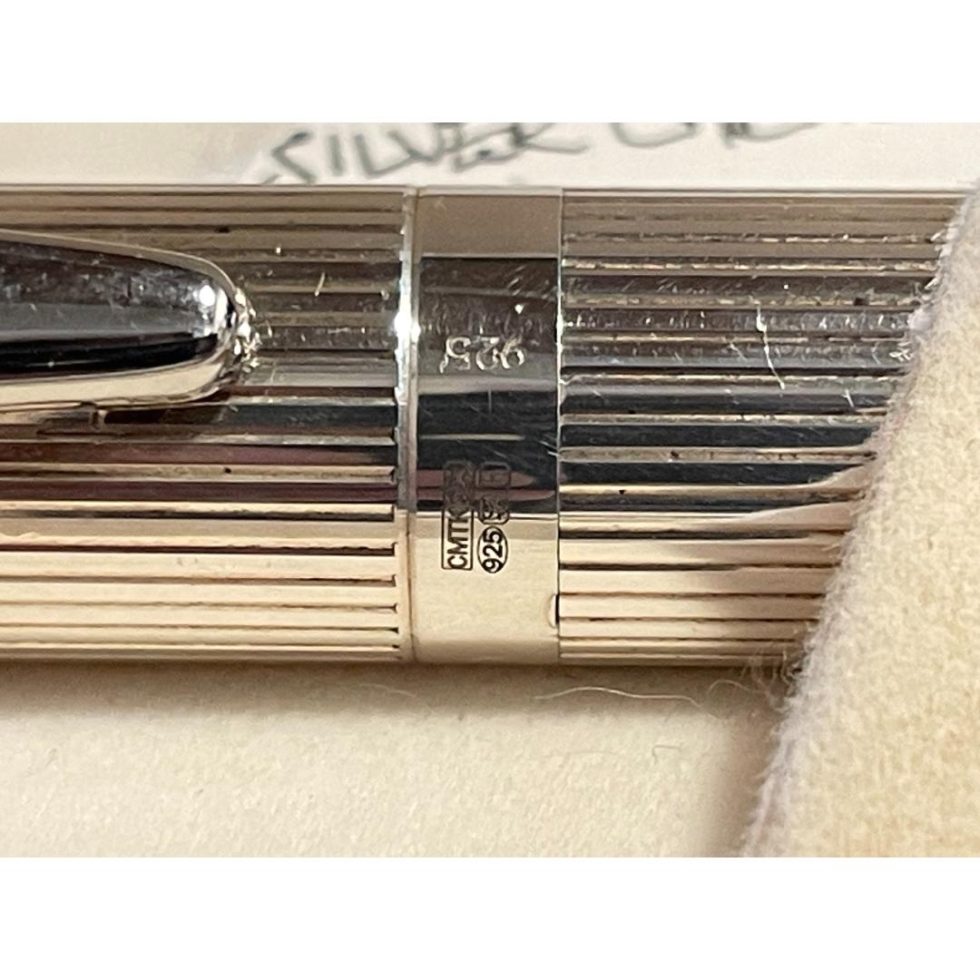 Close up photo of the hallmark on the bottom rim of the pen lid.