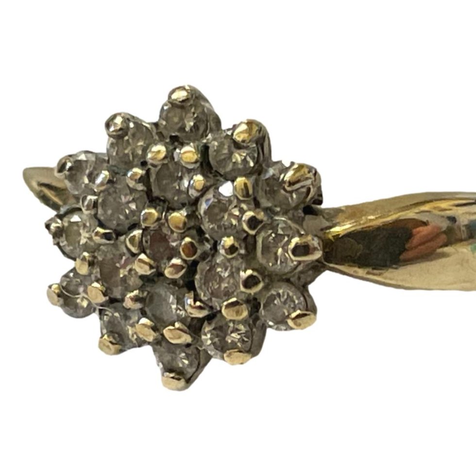 Photo of ring with front facing bottom left corner showing the cluster head in close up.