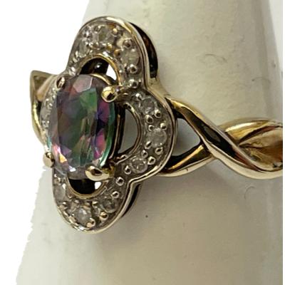 A close up of the ring front which is now turned slightly to left. The setting for the mystic topaz is shown and the twist in one shoulder.