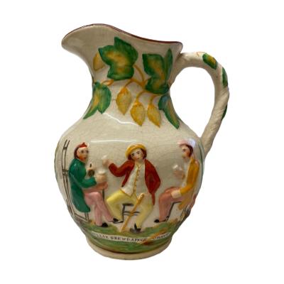 The vintage jug with three friends enjoying a beer features an amusing scene amongst the hops and vines. Beautifully hand- painted and extremely decorative it will brighten any room. Some signs of crazing. COLLECT FROM STORE ONLY. Main photo of jug with spout to the left and handle at the right.