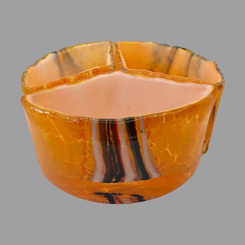 Main photo of all three pieces laid out a circle with each third creating the whole., The overall colour is a vibrant orange with brown and white vertical strips around the centre area of bowl exterior. Each segment of bowl has different strips.