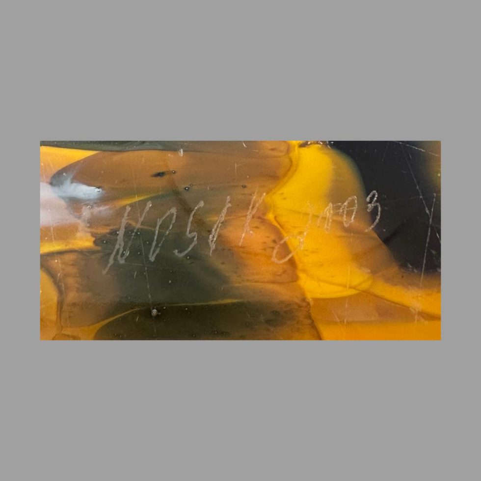 Close up photo of the artists signature to the base of one bowl segment.