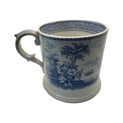 A Vintage Blue & White Staffordshire ironstone frog mug. There is some slight discolouring and crazing commiserate with age. Main photo of mug seen with handle to the left and image of garden with flowers and urn with gondola and mountains in the background.