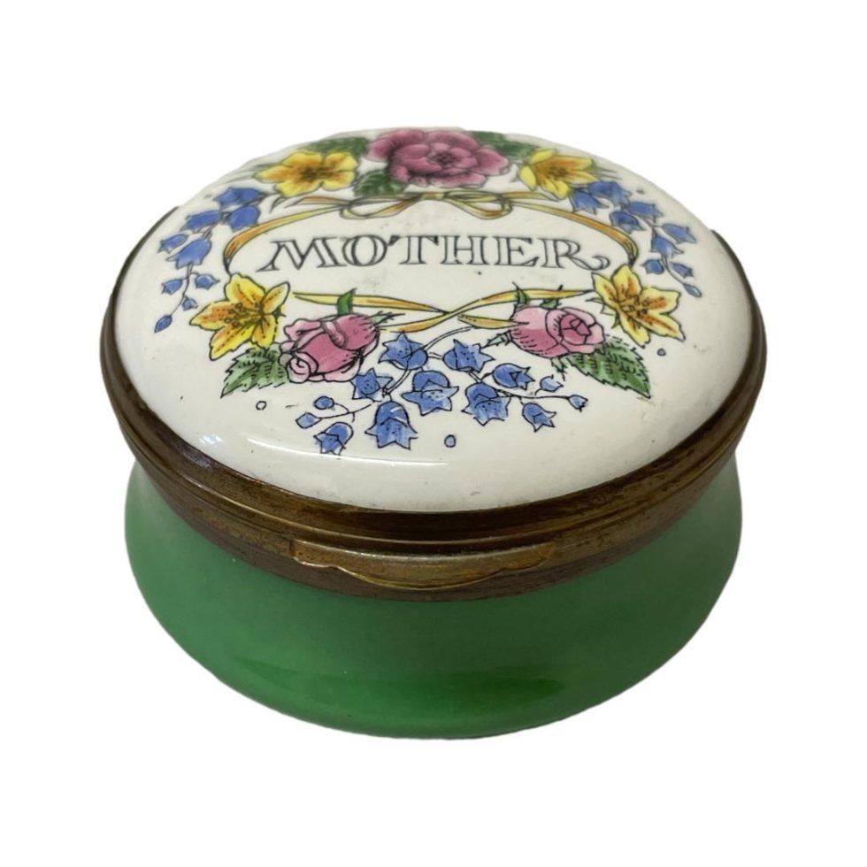 Main photo of box seen from a slightly raised angle showing the design on the lid and green enamel to the sides.