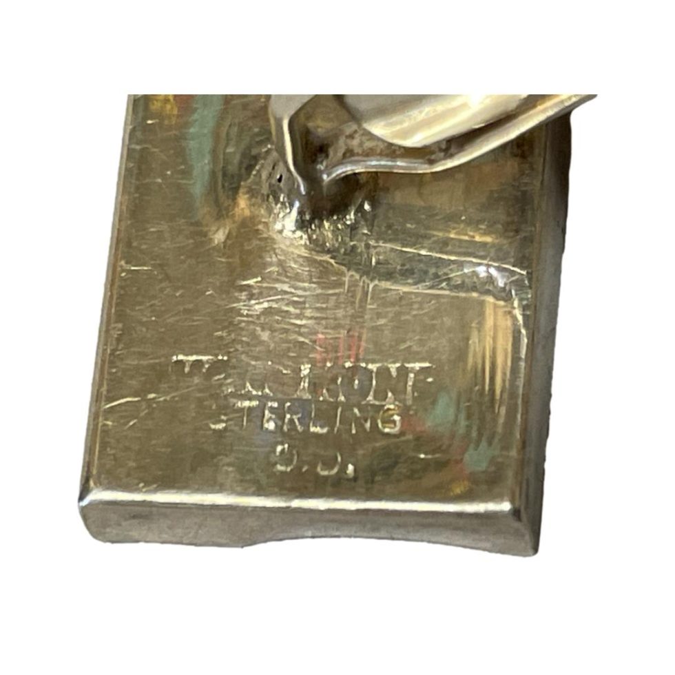 Close up photo of one of hallmark on back of one cufflink.