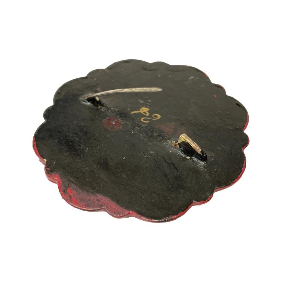 Photo of back of brooch with pin shown open.