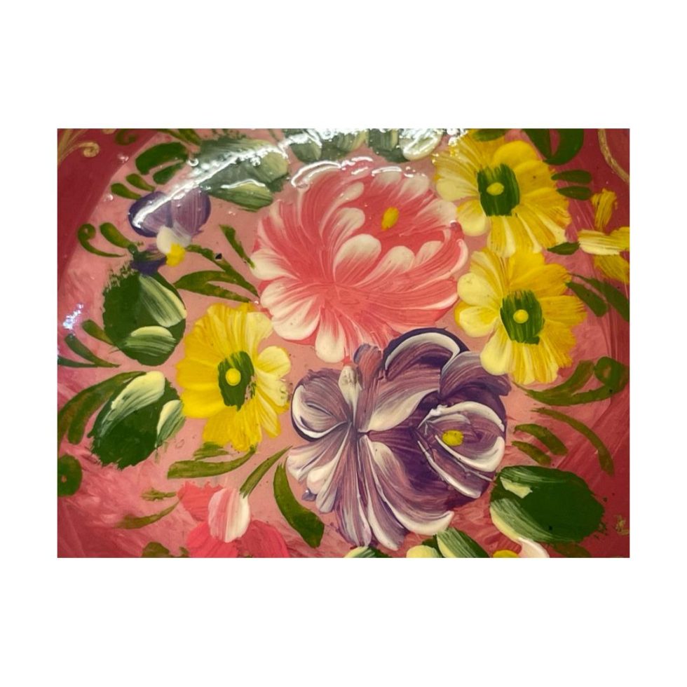 Close up photo of the flowers in pink lilac and yellow at the centre of the brooch