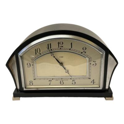 Art Deco 8 day timepiece. A lovely timepiece in a sleek geometric Art Deco fashion in silver & black. c1930s. Keeps excellent time. Needs a full wind every 7 days. Fully serviced and guaranteed for 1 year from date of purchase. COLLECT FROM STORE ONLY. Main photo of clock seen from the front.