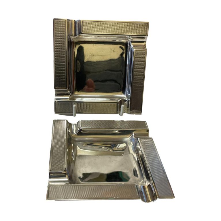Main photo of both ashtrays with one at the back placed upright on a display stand and other placed in front.
