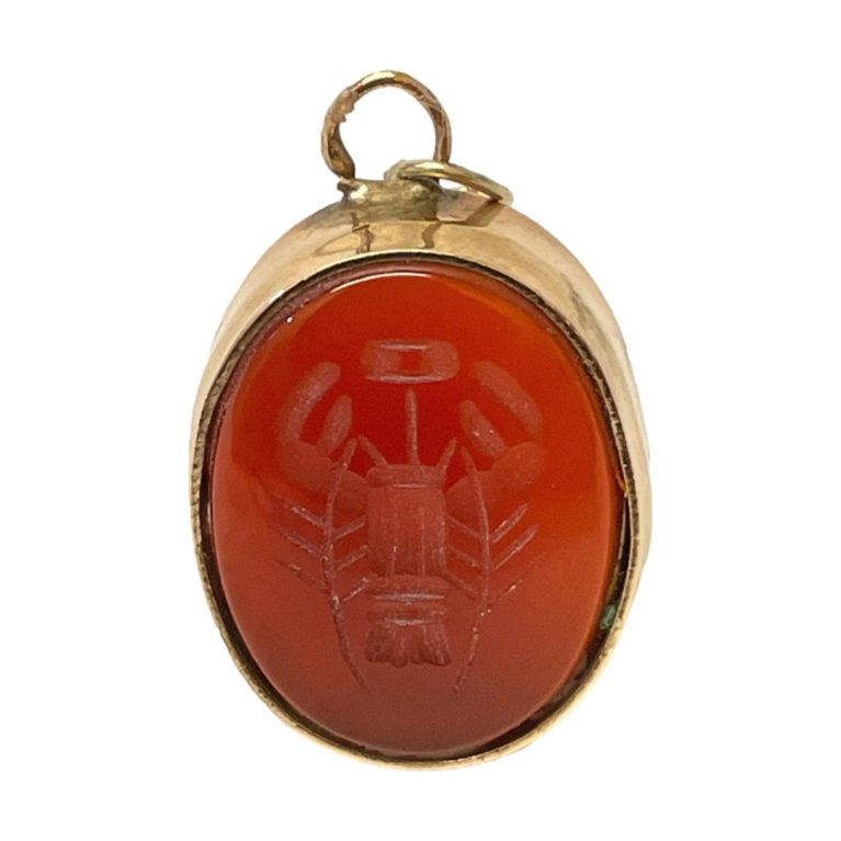 Main photo of intaglio shown posed upright and from the front with lobster carving visible in the carnelian.