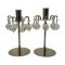 Main photo of both candlesticks shown side by side and from an eye level. Round base, slender central stick with sconce at top. The crystal drops hang all the way round sconce- 8 to each.
