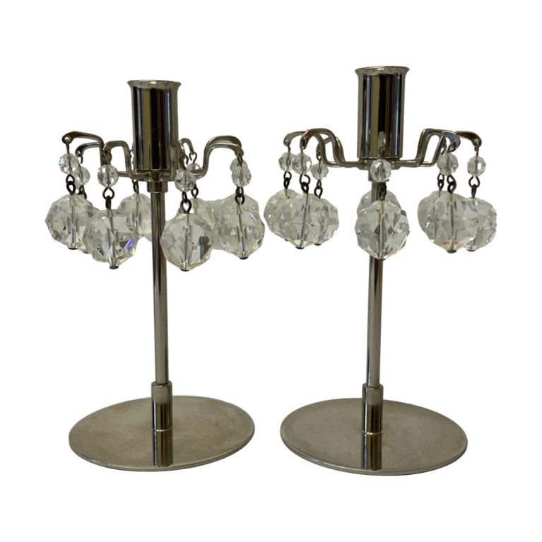 Main photo of both candlesticks shown side by side and from an eye level. Round base, slender central stick with sconce at top. The crystal drops hang all the way round sconce- 8 to each.