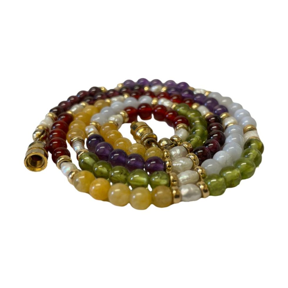 Photo of the necklace curled up into a circle (like a sleeping snake) on a flat surface.