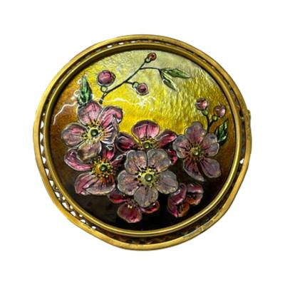 Antique hand-painted enamel brooch. Beautiful hand-painted enamel brooch of cherry blossoms in bloom against a golden background. Signed by artist L. Joubert Limoges to the back. Measures 57mm in diameter including the gilt metal frame. Trombone clasp in good working order. Main photo of brooch seen from the front. with cherry blossoms along the bottom half edge of brooch and golden enamel background to the top.