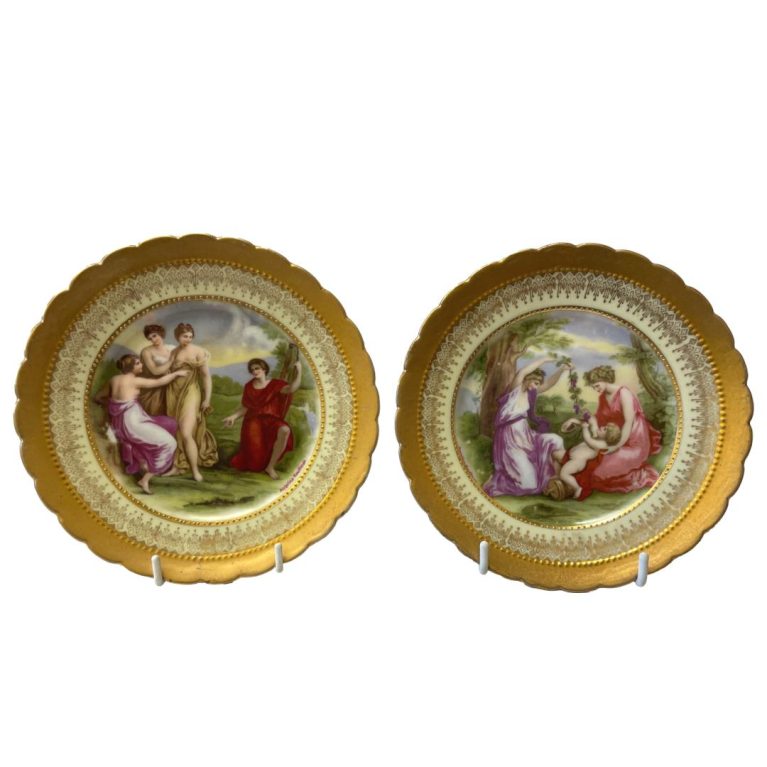 Main photo of both plates displayed upright and side by side. On the left a group of 4 women either preparing to or having just bathed in the nearby river and on the other, 2 ladies playing with a baby.