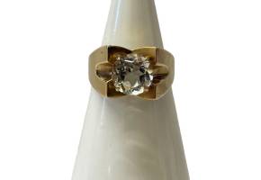Vintage 9 karat gold and aquamarine ring. Modernist 9 karat gold ring set with an almost clear round cut aquamarine. Hallmarked for Birmingham assay c1975. Ring size L.5 / 6 Main photo of ring on a cone shaped display stand and seen from the front.