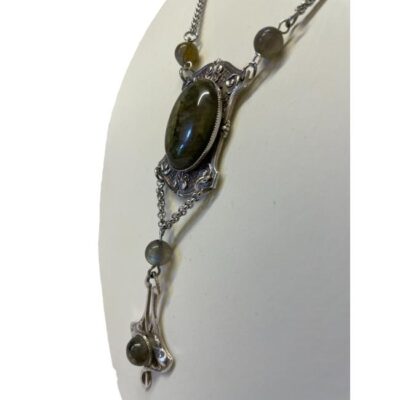 Art Nouveau style necklace. Lovely necklace made from original design plates of the era. This one is in silver plate with labradorite stones. Drop length of pendant area at front is approximately 100mm. Width of top pendant area is 25mm. Photo of pendant area of necklace seen from a slight side angle.