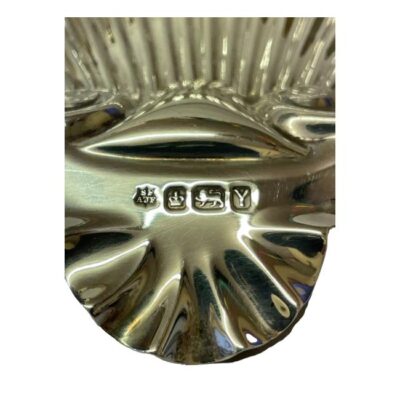 Victorian shell dish in sterling silver. Antique dish in the form of a scallop shell on 3 ball feet. Fully hallmarked for Sheffield assay and made by Fenton Brothers c1891. Close up photo of the full hallmark on the lip of the scallop.