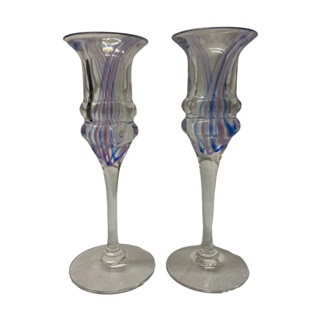 Pair of Art Deco liqueur glasses. Pretty pair of funky Art Deco liqueur glasses with pink and blue candy stripes flowing from one side to the other. A nice weighty glass with double ridge to the glass bottom making them very easy to hold. As they are handmade, there is a slight size difference as well as colour/width of the blue and pink stripes. Measures approximately 52mm at base, 45mm at top and 140mm tall. Photo of both glasses side by side shown in full. The glass stems and bases look off white but it is clear glass. The photo has picked up the colour of the paper the glasses were on.