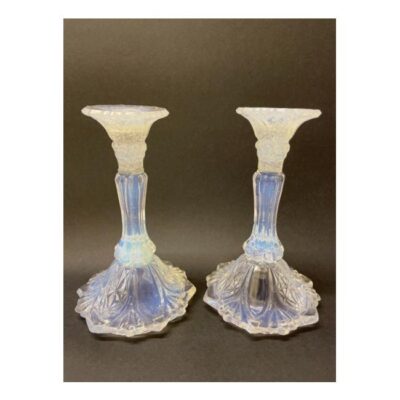 Pair of 1930s vaseline glass candlesticks. A fabulous pair of Art Deco candlesticks made of vaseline glass. The colour changes from pale blue to yellow with hints of pink depending on the angle & light. The sconce area or top of the candlestick has specks of white dots in the glass giving an effect of snowing. There is a very slight size difference therefore measurements are approximately given. Base 115mm in diameter, top 65mm in diameter with candle slot at 20mm and 180mm tall. (782gms) Main photo of both candlesticks displayed side by side on charcoal background to bring out the blue colour which is not as visible with a plain white background.