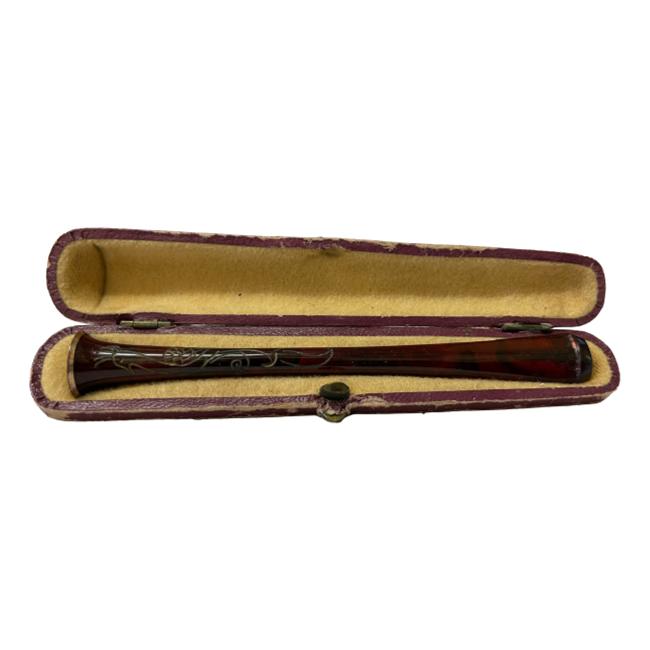 Victorian cigarette holder in original case. Elegantly shaped cigarette holder with an exotic bird engraved on the cigarette end of holder. Gilt metal band to the end. Holder measures 102mm long. Case has some signs of wear. Main photo of the cigarette holder displayed inside its open case. The cigarette end is on the left.